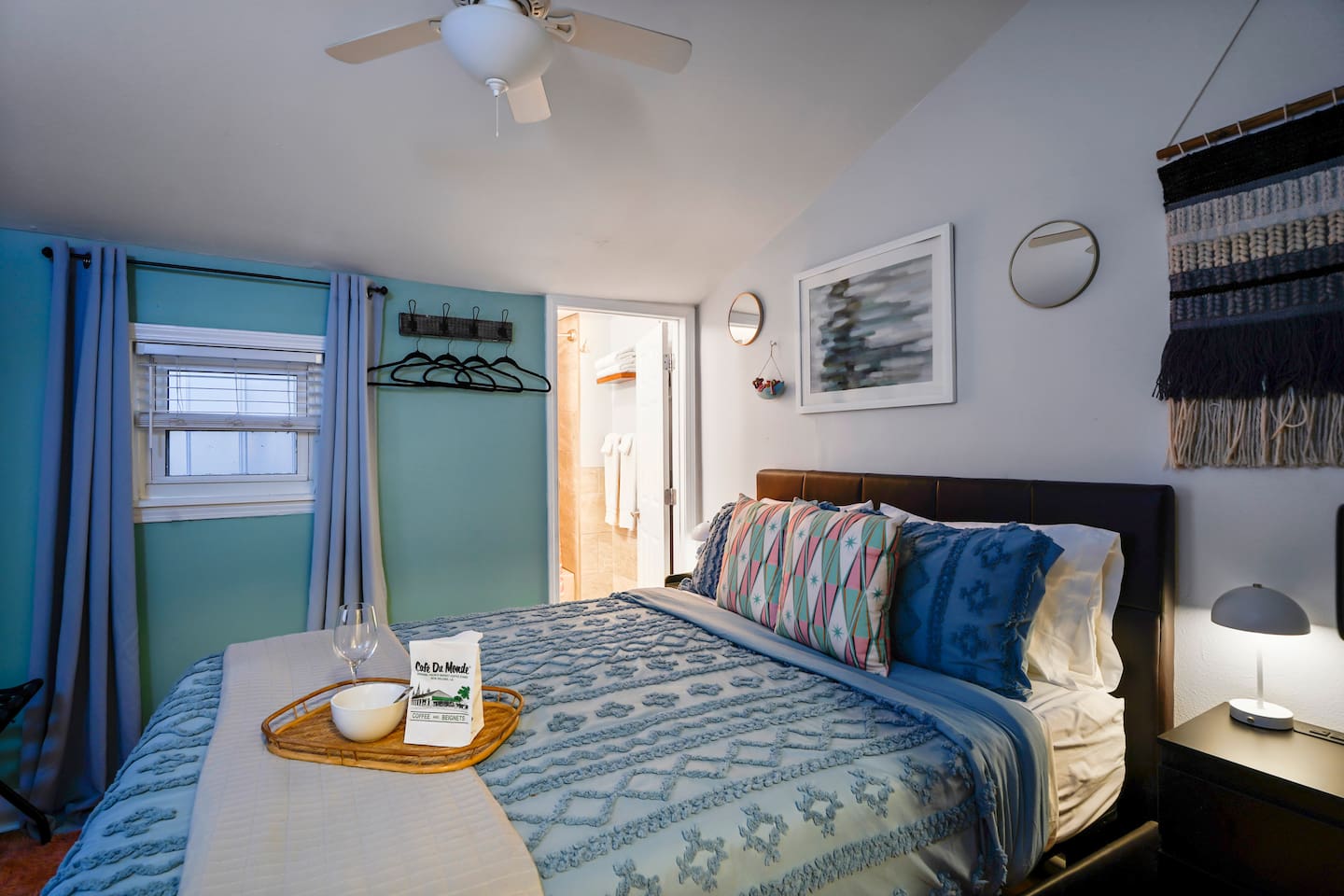 The Blue Room is cozy with a queen bed, en suite bath, mushroom-themed decor, fun mood lighting, and direct access to the patio and backyard.