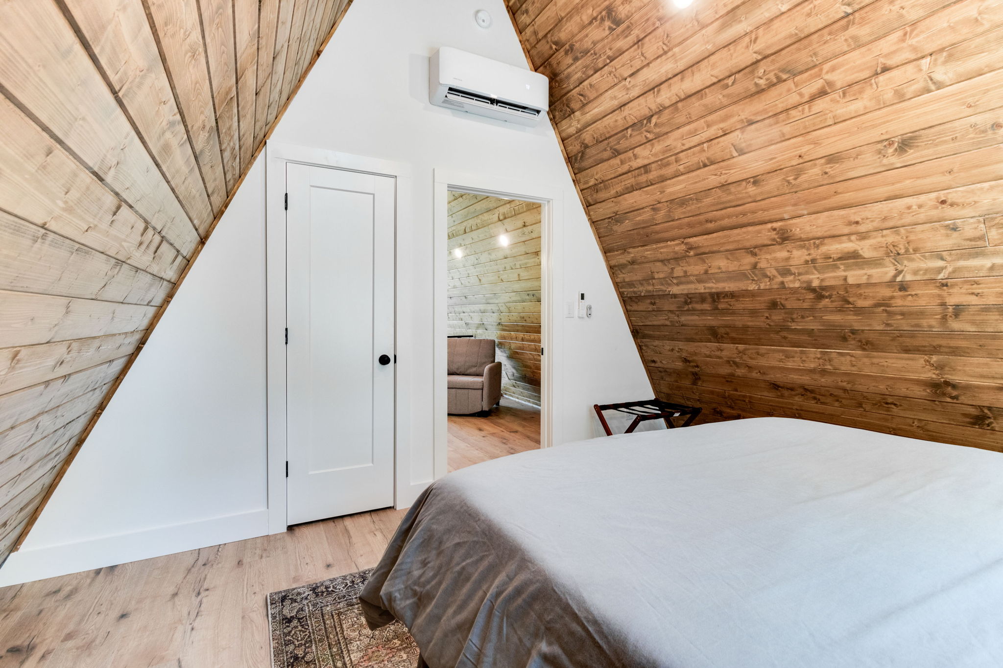 Upstairs bedroom with queen bed and AC