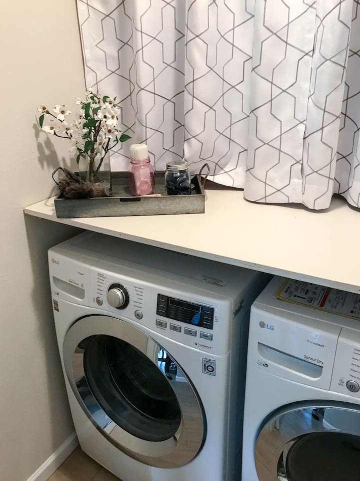 Walk-in Laundry room with front loading washer and dryer