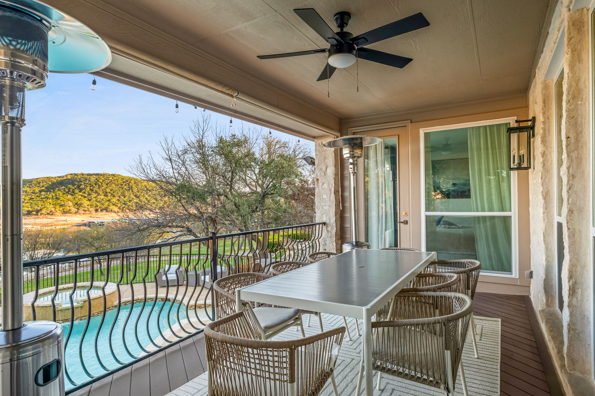 Covered balcony with outdoor dining and stunning Hill Country lake views.