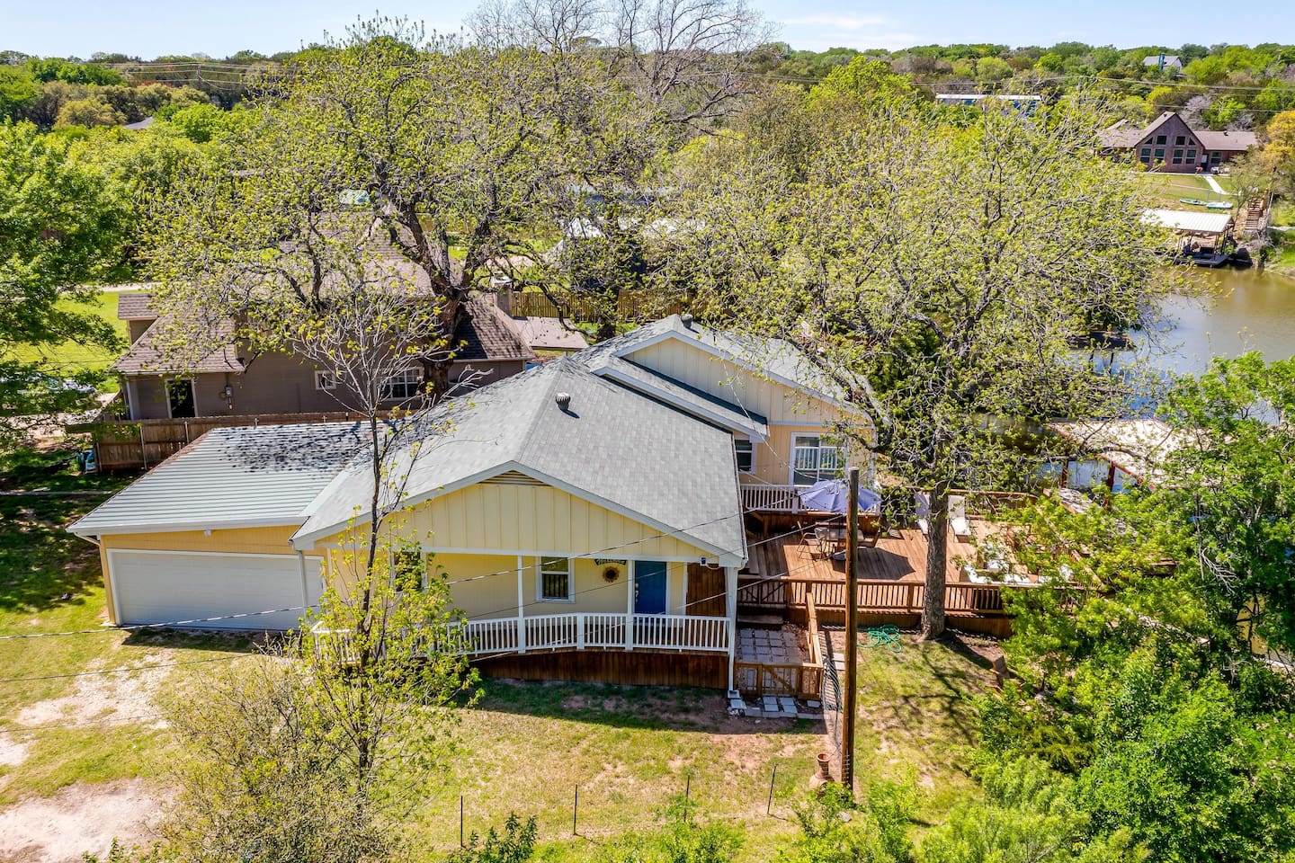 Charming lakefront exterior nestled in a quiet Granbury neighborhood.