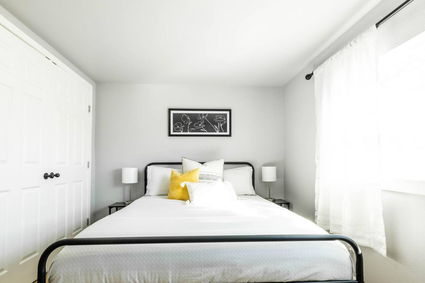 The bright queen bedroom combines comfort and style, featuring soft linens and natural light for a tranquil ambiance.