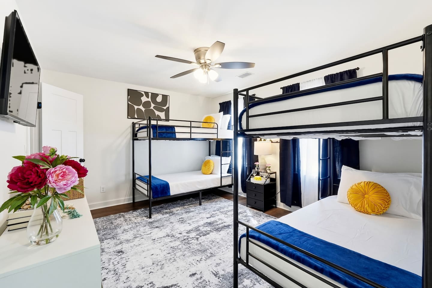 Cozy second-level bedroom with two bunk beds, each with blankets and a Roku TV. First room you see at the top of the stairs. Includes 4 full-body towels, 4 washcloths, and 2 hand towels for your stay.