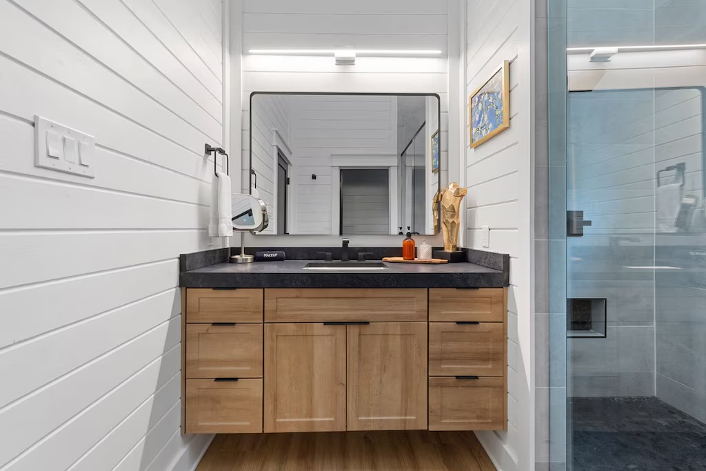 Sleek Bathroom Retreat: Enjoy elegant fixtures, stylish decor, and ample space to refresh!