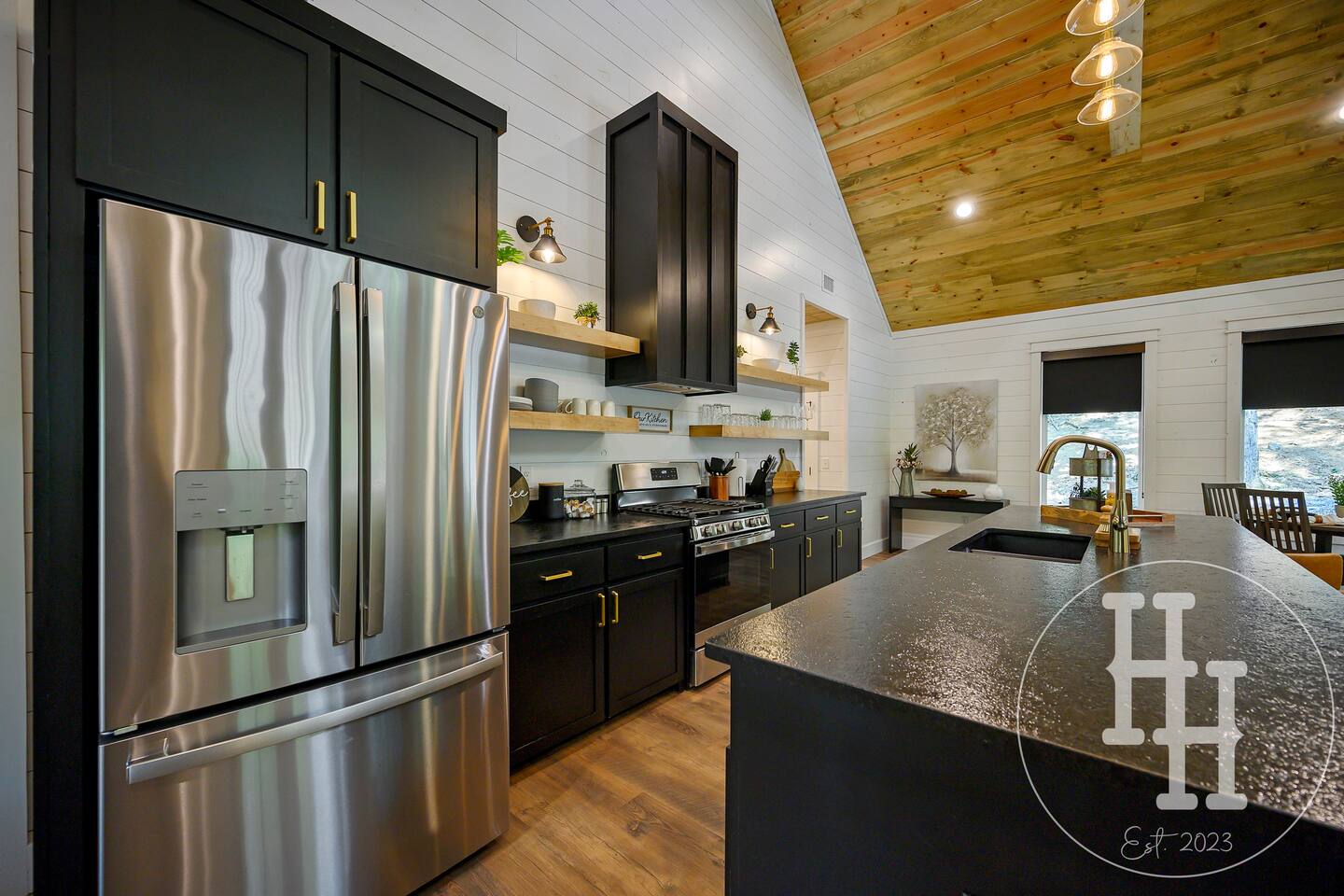 Large refrigerator and freezer complete with water and ice in the door.