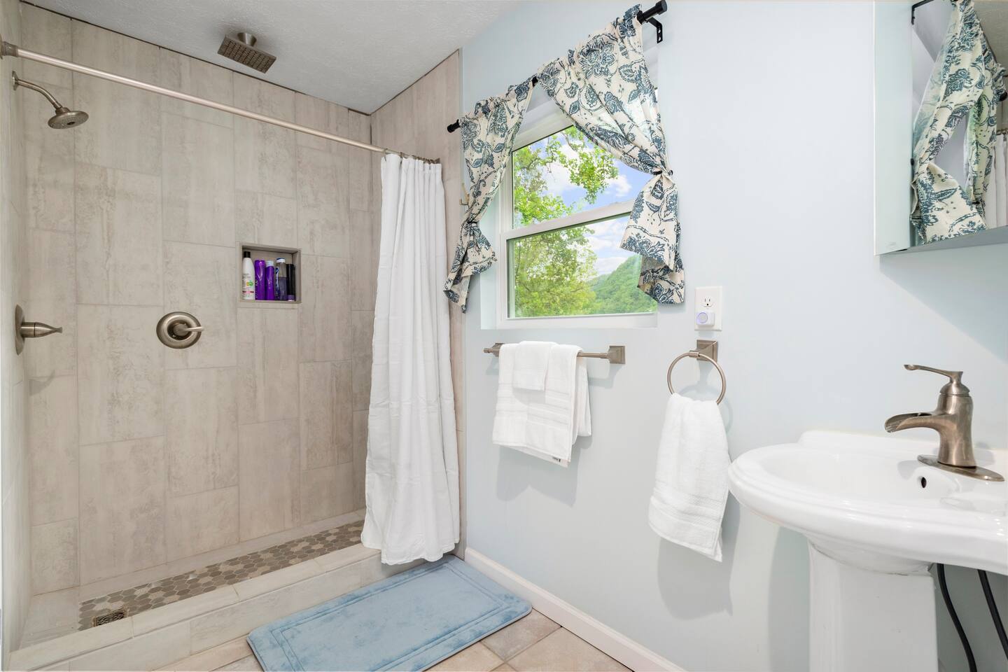 Bathroom one is accessed through bedroom one and has a walk in shower