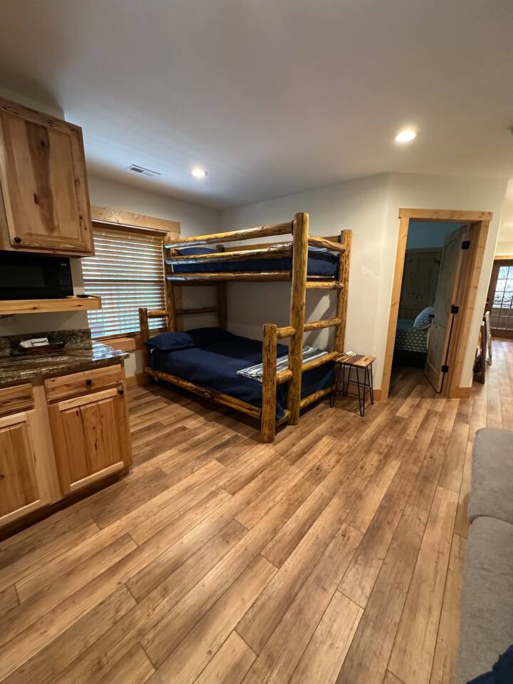 Lower level of the cabin with bunk bed & sofa
This area also has a sink, fridge, & cabinet space.