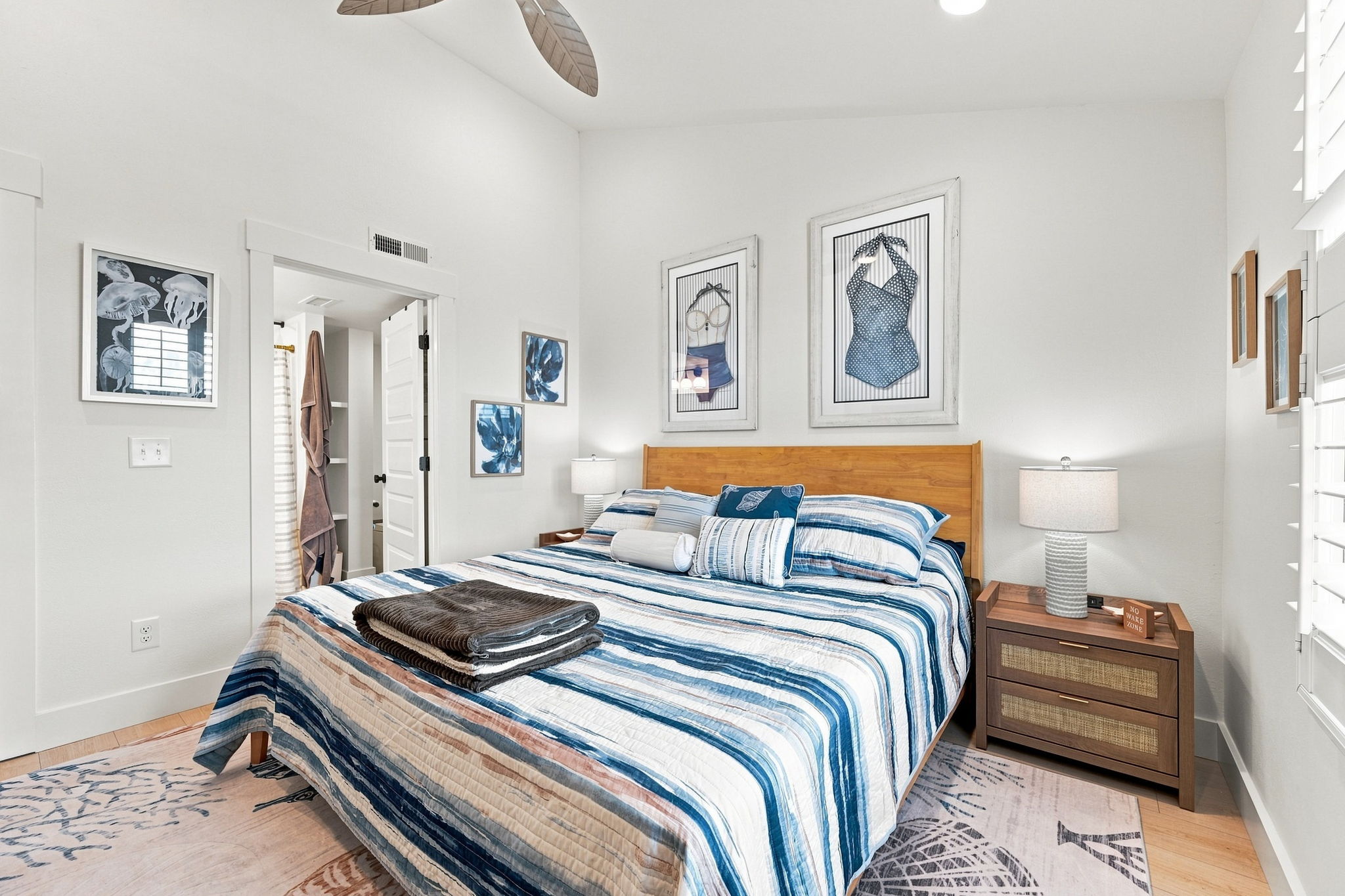 A king-sized escape in shades of coastal blue, layered with plush textures and breezy decor. The perfect place to unwind, recharge, and dream by the sea. 