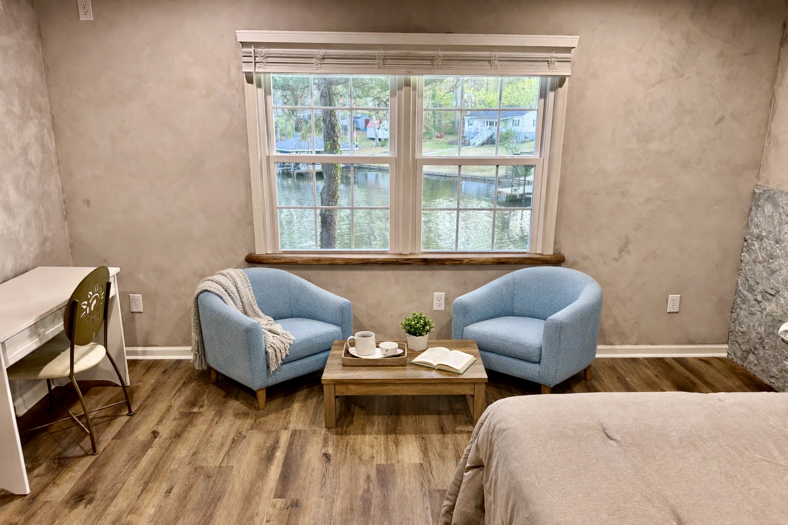 Master bedroom, sitting area overlooking the water and desk.