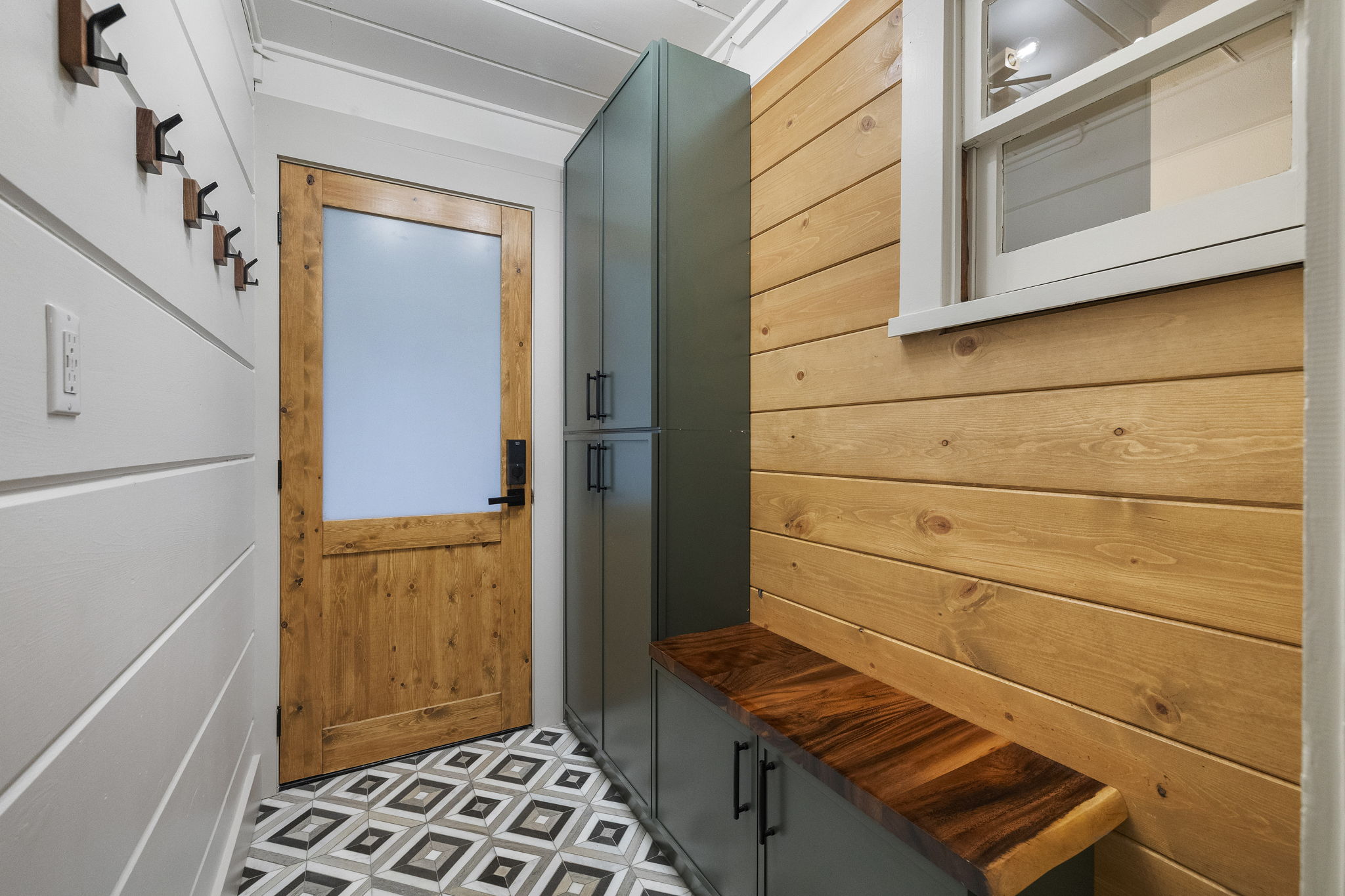 Newly added mud room off the back deck, A space to hang your belongings, put on your shoes and find backup supplies like paper towels should you need them.