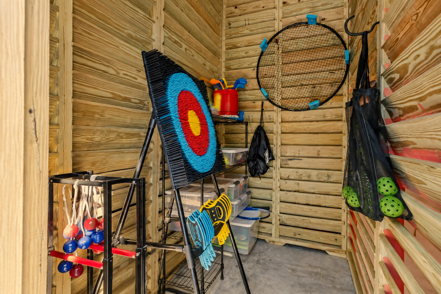 Fully stocked yard game closet including Spike Ball, Archery, Ladder Ball, Pickle ball, and Corn hole.