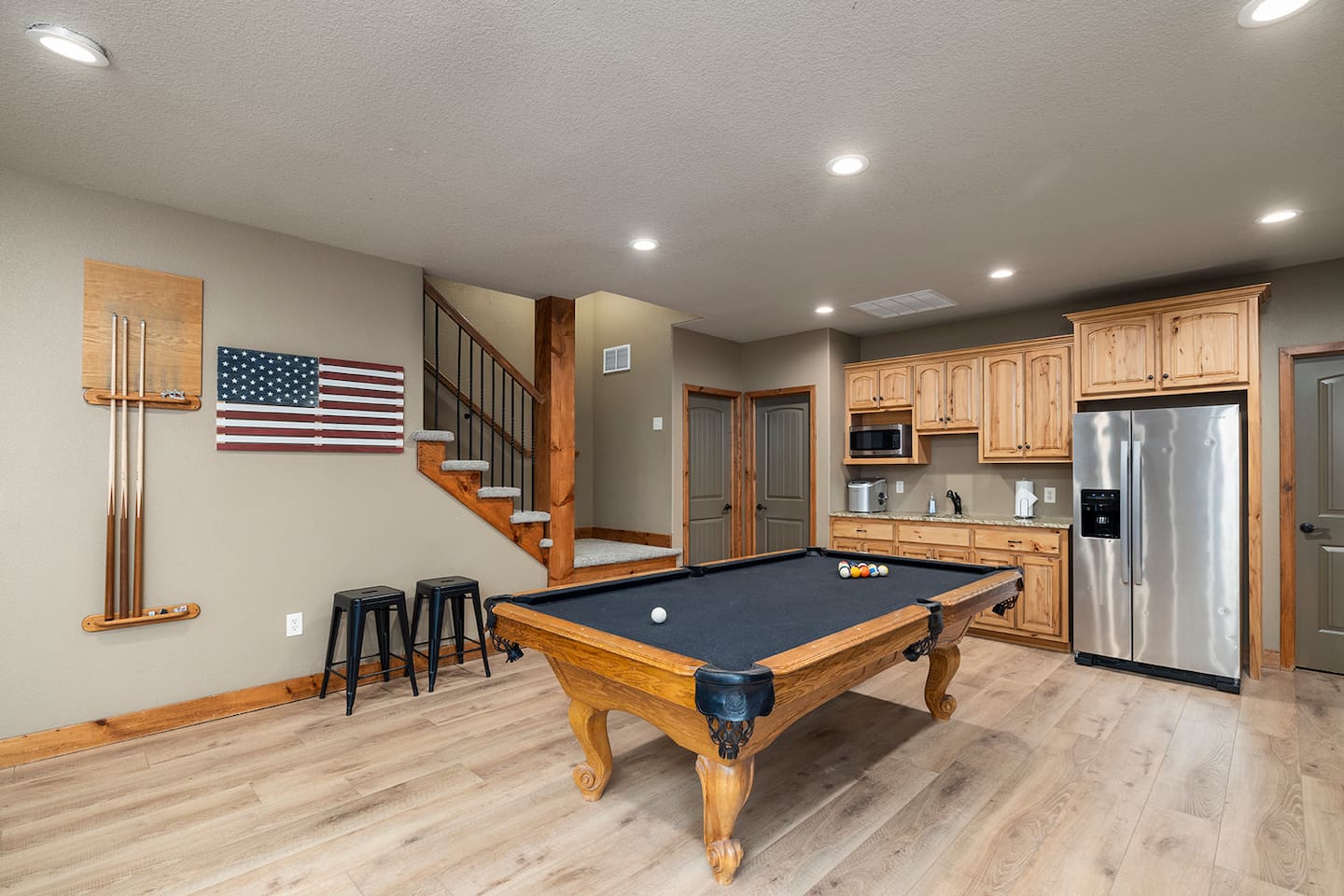 Lower level rec room with pool table, multicade, and kitchenette.  Upgraded flooring
