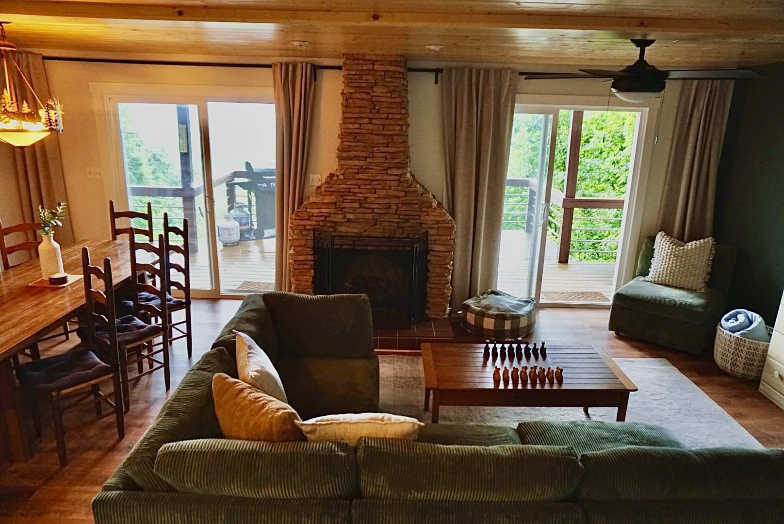 Enjoy stunning views, a warm stone fireplace, and ample seating for gathering fun!