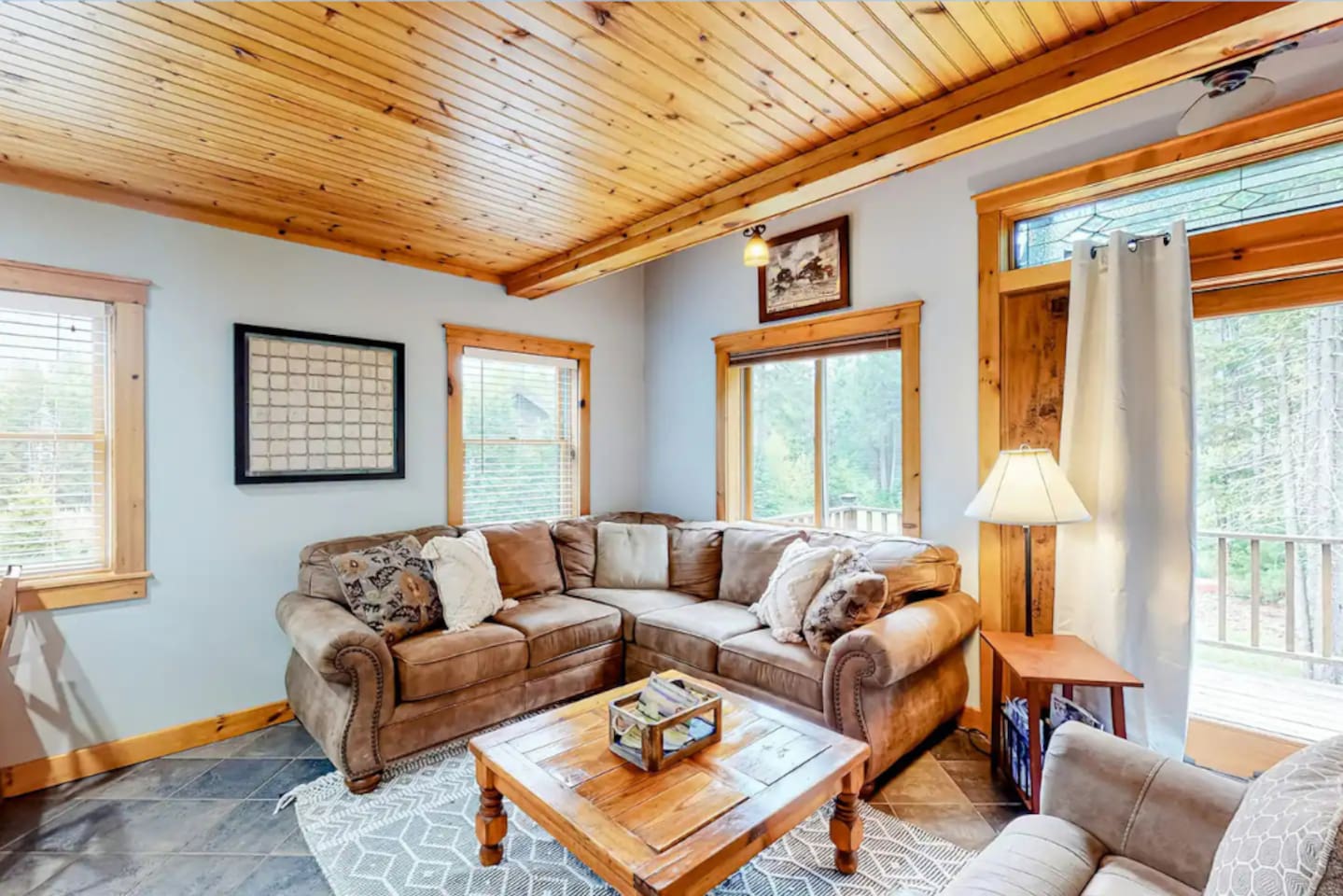 Sit back and read a book on this cozy L couch located in the living room of the home!