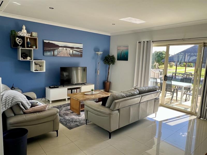 Sunny family room with access to the outdoor BBQ area & swimming pool