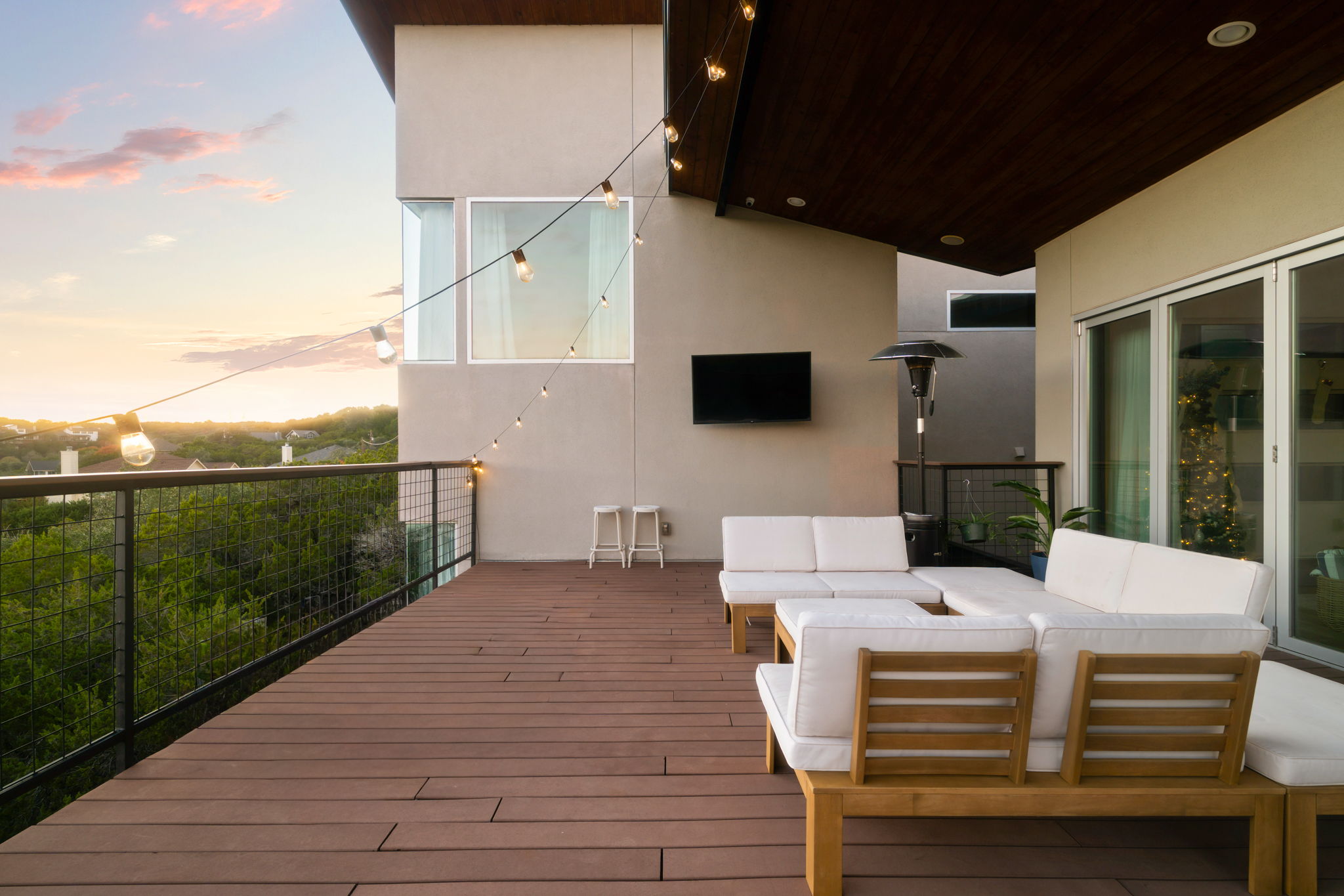 Covered balcony with TV and lounge area