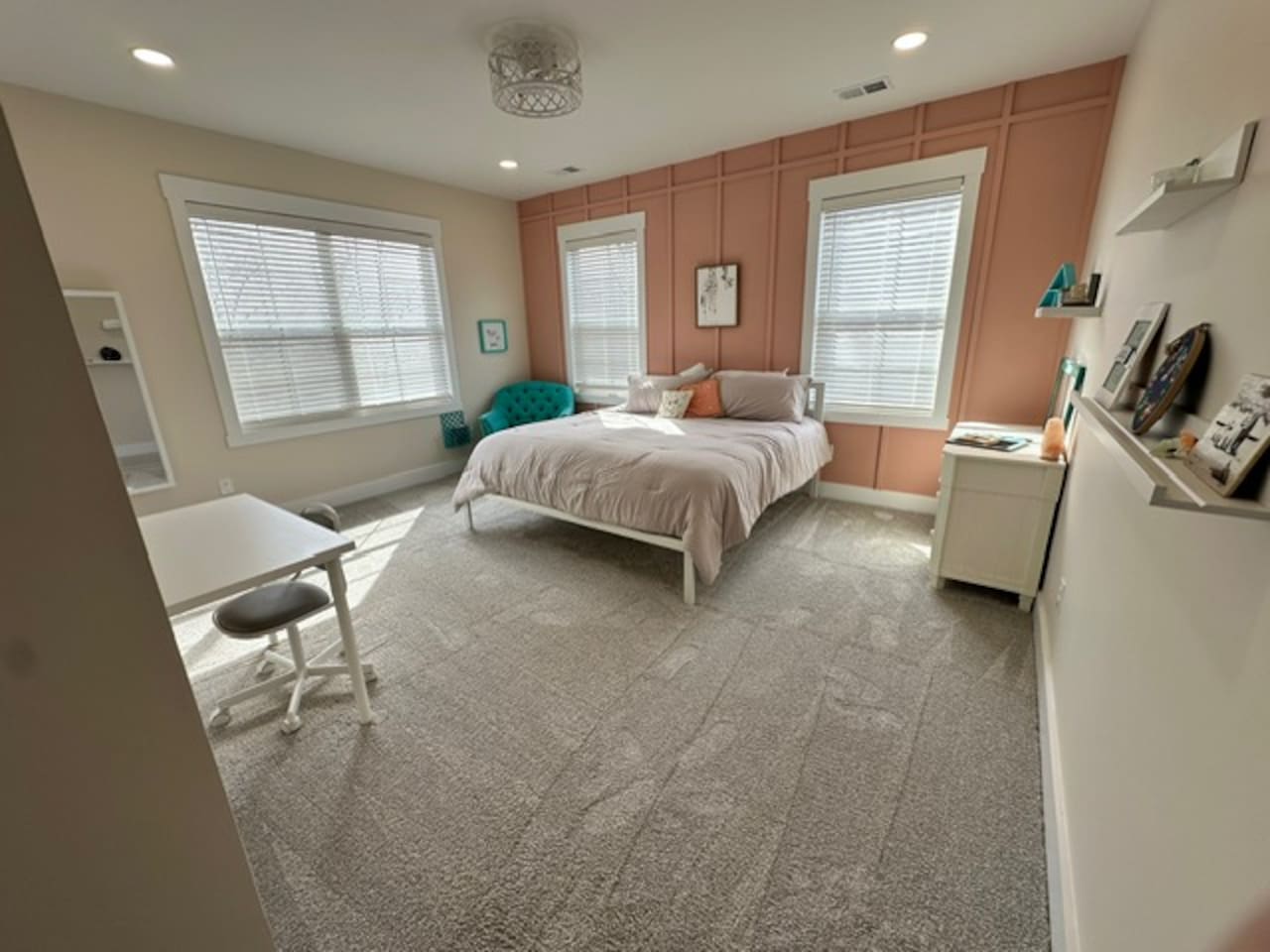 Bright and cheerful, with a super comfy chair for reading and a desk. Private sink and makeup vanity area with access to private toilet and shower rooms, which are shared with bedroom #5. 