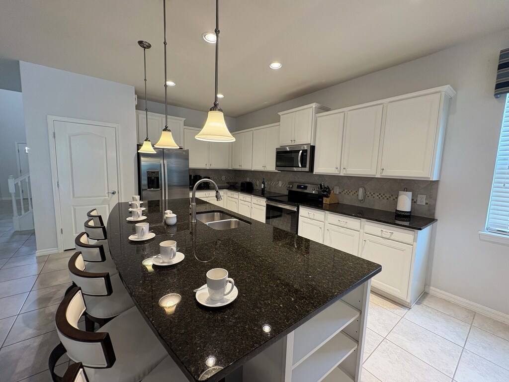 Fabulous island with lots of storage and decorative stools that seats 6