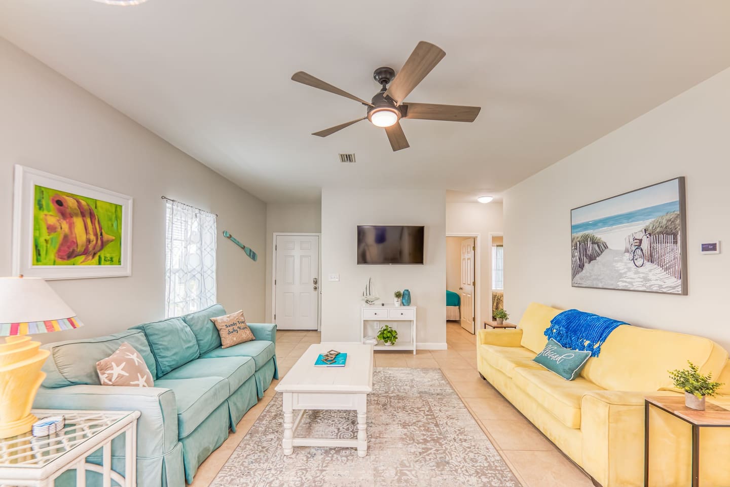 Living Room: Bright and inviting space, perfect for relaxation with beachy decor and natural light!