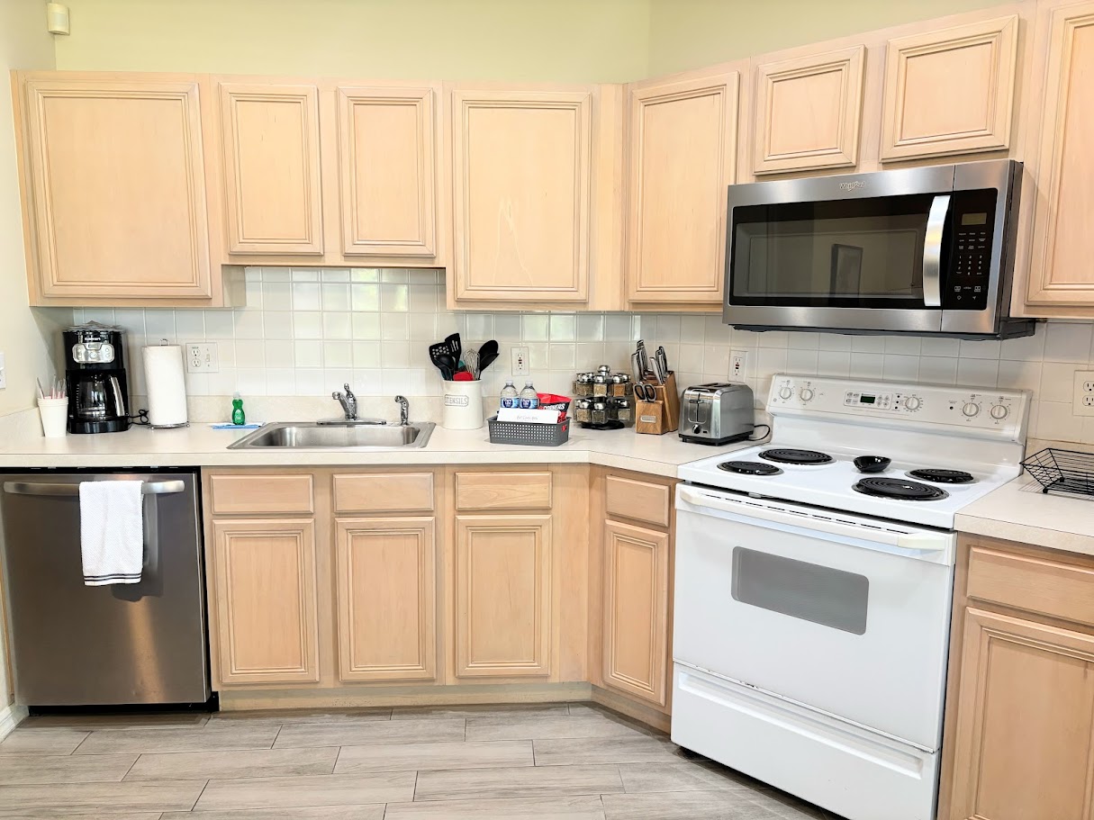Functional kitchen with full-size appliances, ample cabinet storage, and a clean, convenient layout.