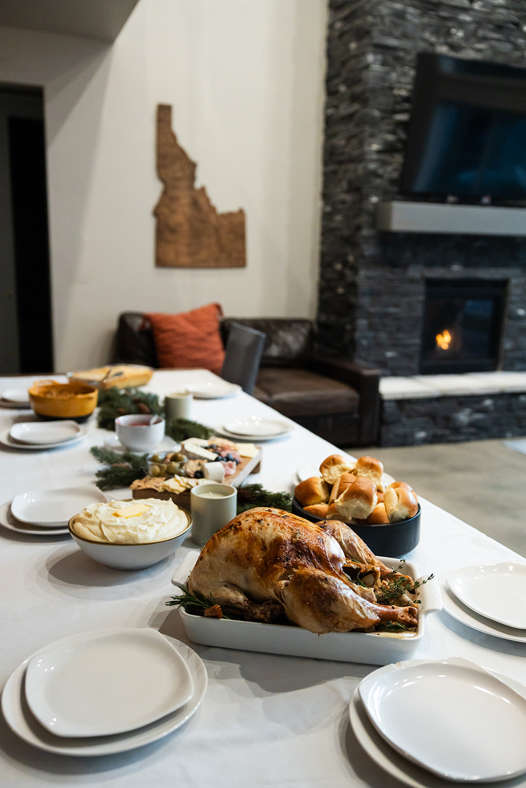 Cozy dining next to a warm stone fireplace.