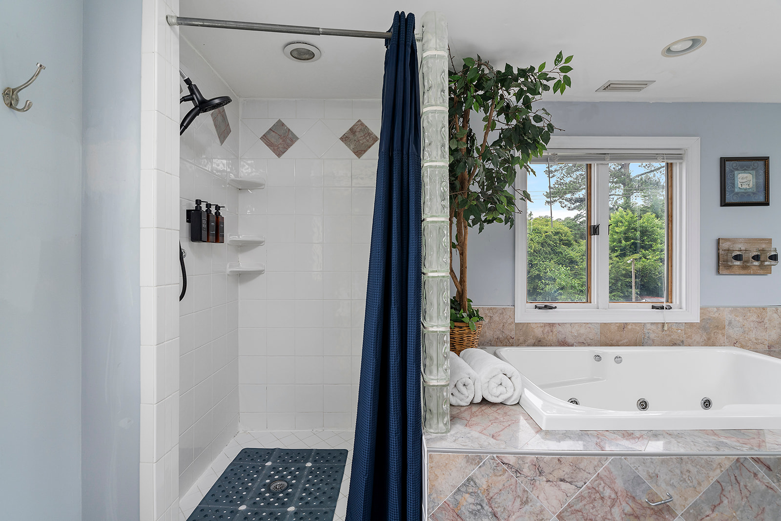 Master Bathroom 1: Indulge in relaxation with a luxurious soaking tub and scenic views!