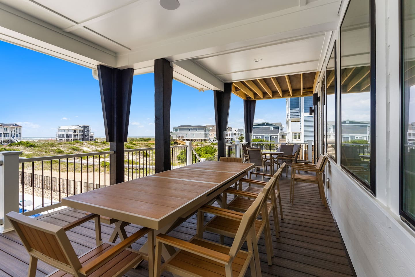 Indoor-outdoor living at its finest. Just off the living room, this expansive oceanfront deck overlooks the private pool and beach, offering the perfect space to relax, dine, and soak in the views.