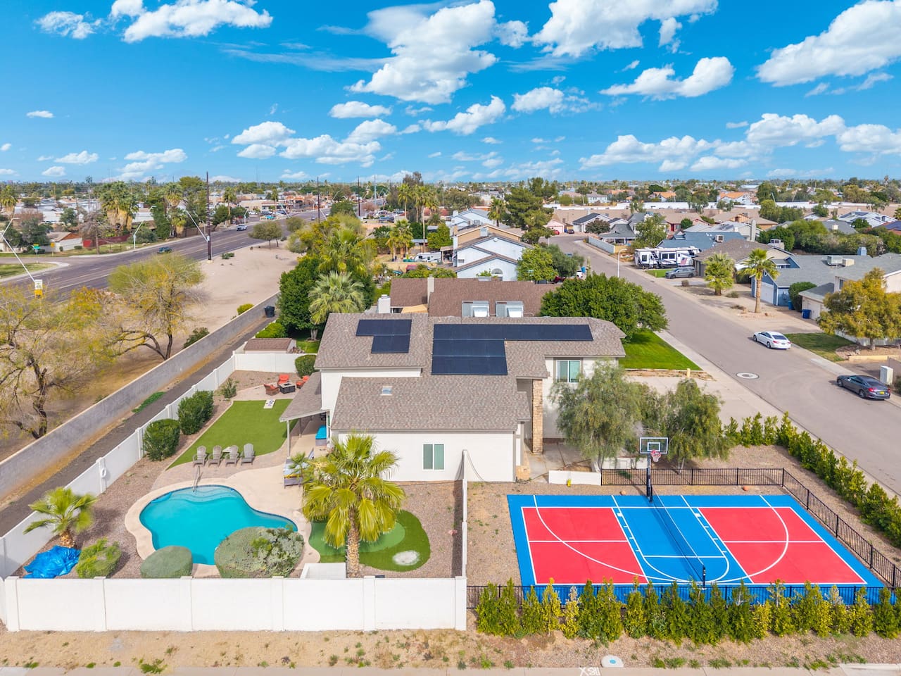 Luxury estate with resort pool, sports courts, solar panels, and sprawling grounds—the ultimate group retreat.