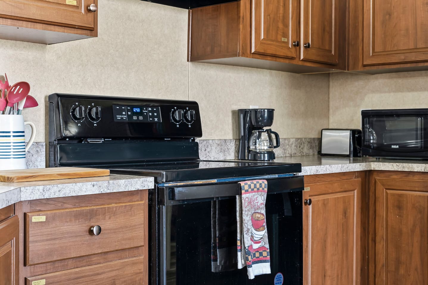 Clean and modern cooking space with electric stove, prep area, and all the basics for a comfortable stay.