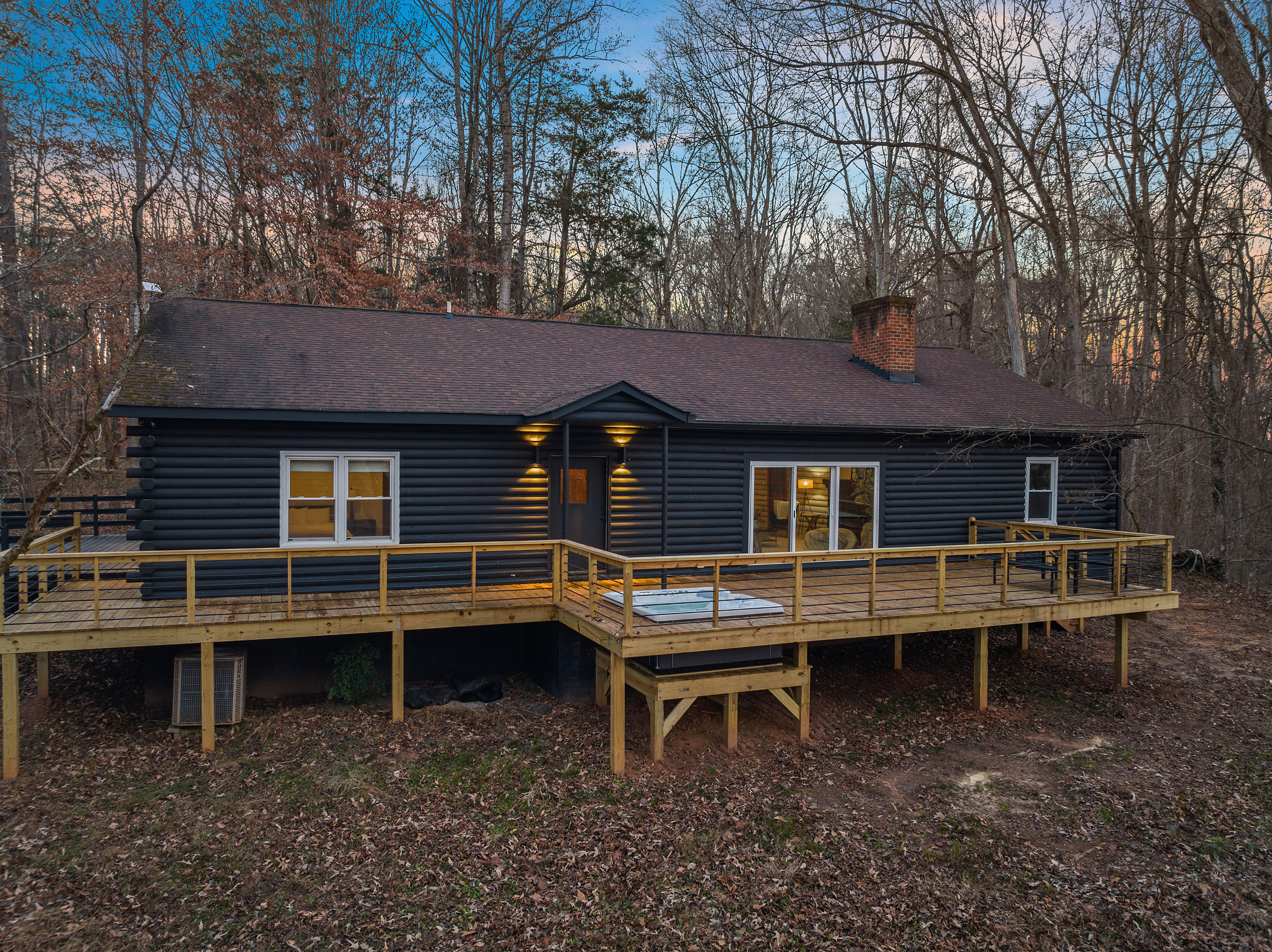 Exterior Retreat: Enjoy peaceful evenings on the spacious deck surrounded by nature's beauty!