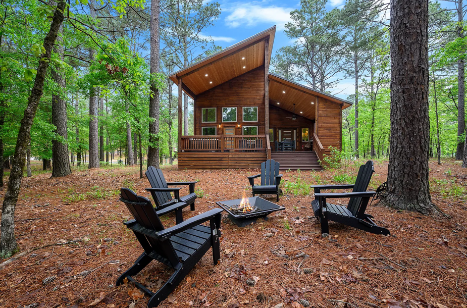 Charming modern cabin with outdoor fire pit seating and cozy forest vibes
