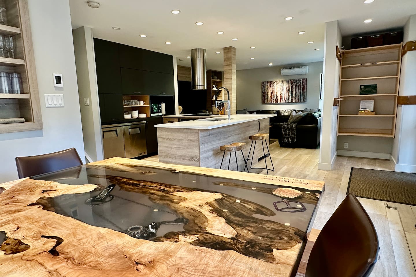 Kitchen flows effortlessly into the dining space, anchored by a huge custom Live edge Maple wood table. 