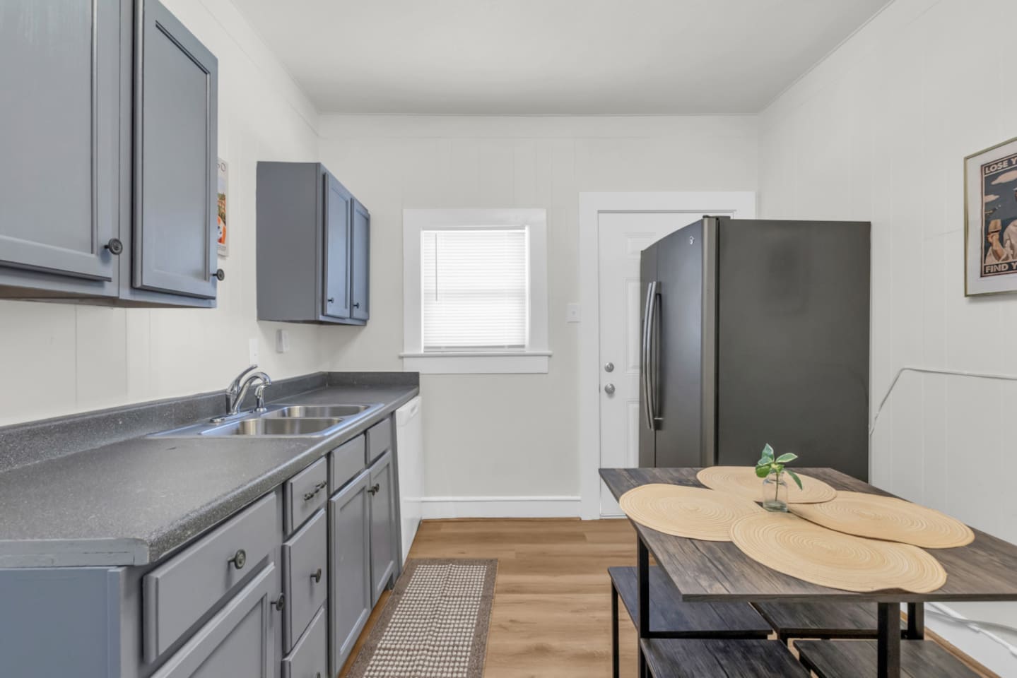 Open kitchen with island style seating and stainless steel appliances.