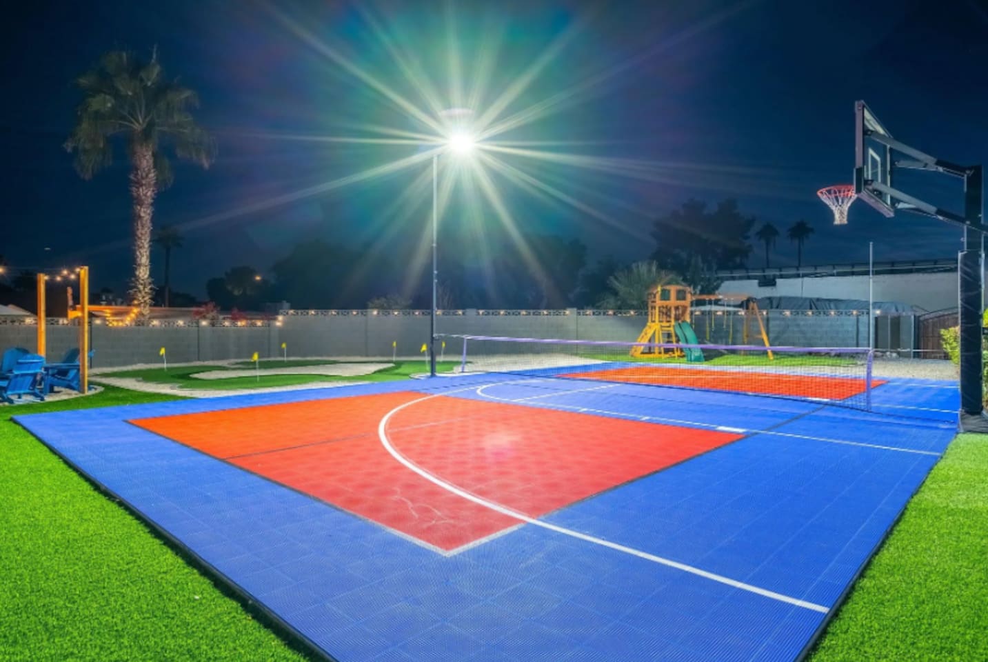 Full-size basketball and pickleball court, lit up and ready whenever the group wants to run it back.