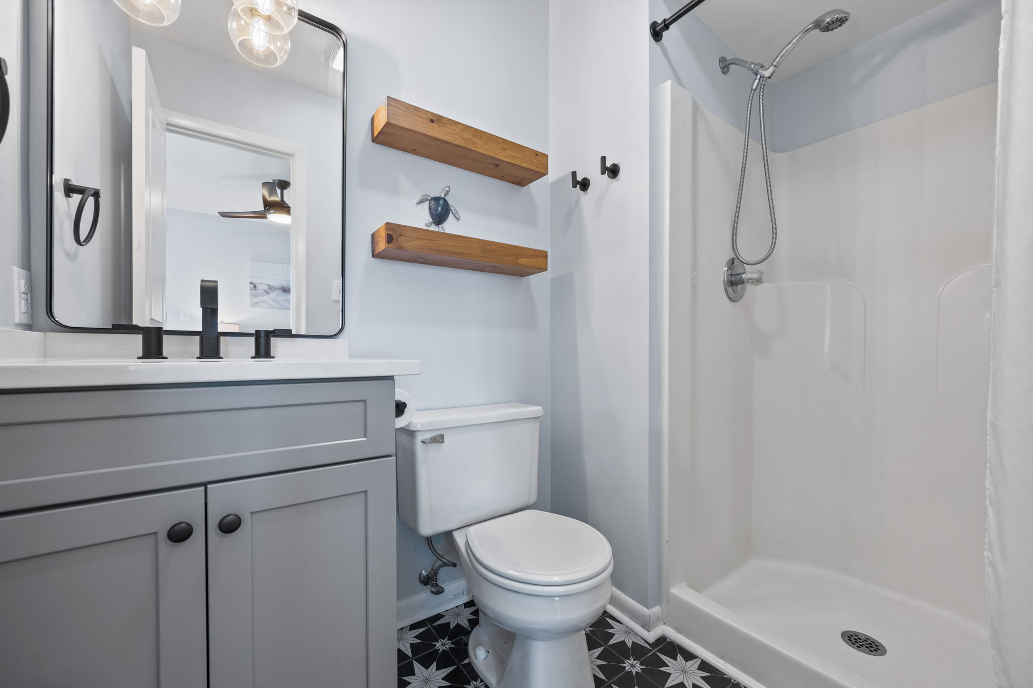 Full ensuite bathroom with updated floors and vanity