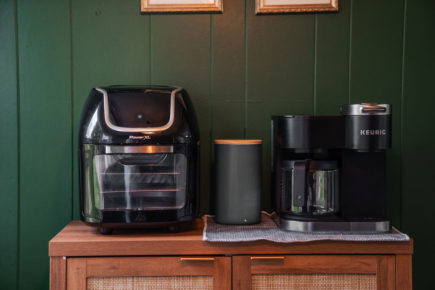Coffee maker and air fryer, along with cups in cabinet