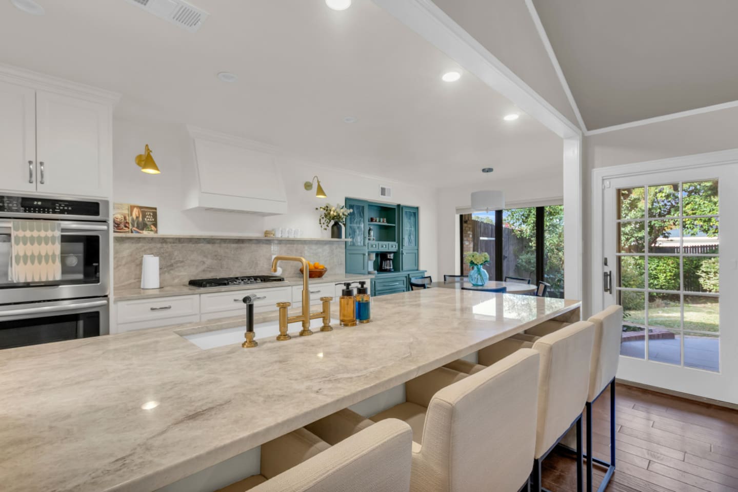 Huge kitchen anchored by an oversized island, offering ample counter space for cooking, meal prep, and casual dining. Designed for both function and style, the open layout makes it easy to gather, entertain, and move seamlessly between the kitchen, l
