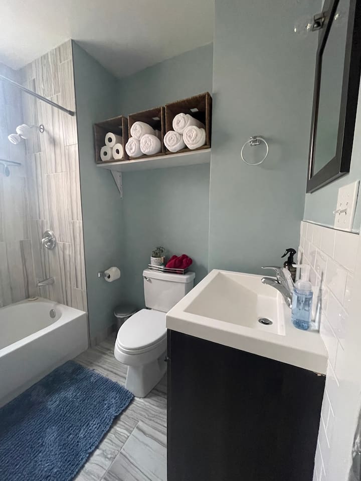 Bright bathroom stocked with fresh towels and guest essentials.
