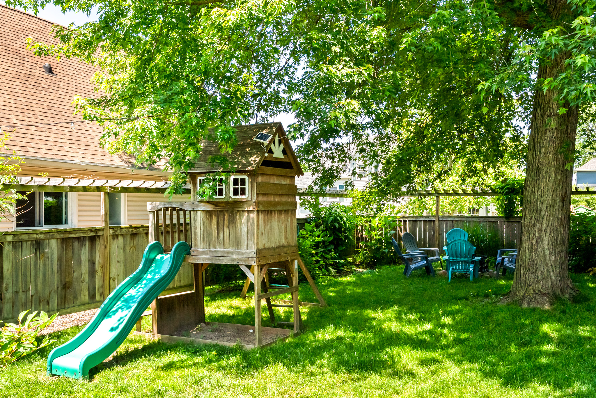 Total kid paradise! The backyard features a wooden playset and treehouse club, keeping the little ones fully entertained while the adults relax on the patio or enjoy a little family competition of cornhole, giant yatzee and connect 4 and more.