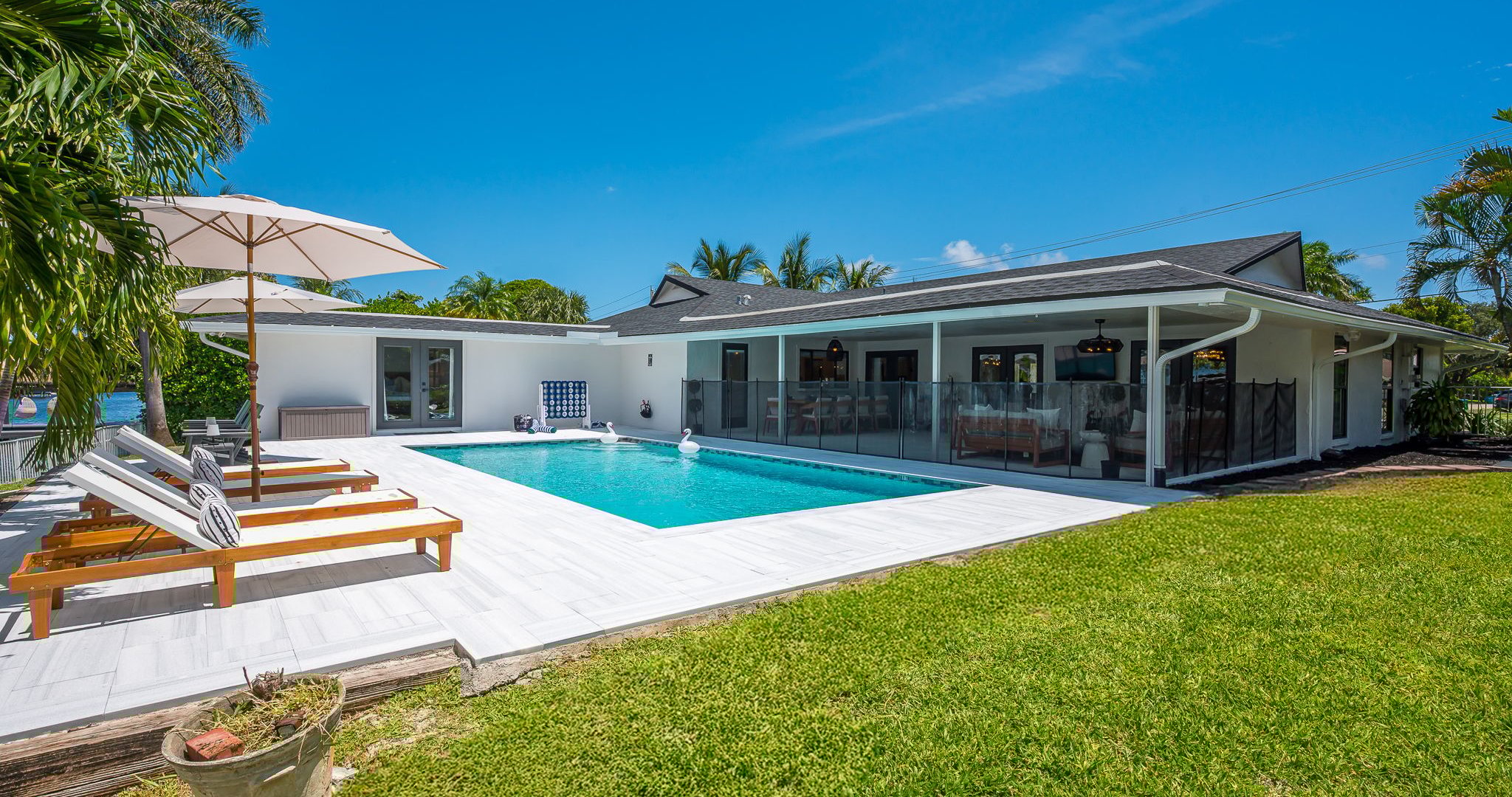 Spend your days lounging by the shimmering pool, dining al fresco under the covered patio, and unwinding in stylish outdoor living spaces—all set against a serene lakefront backdrop with private dock access