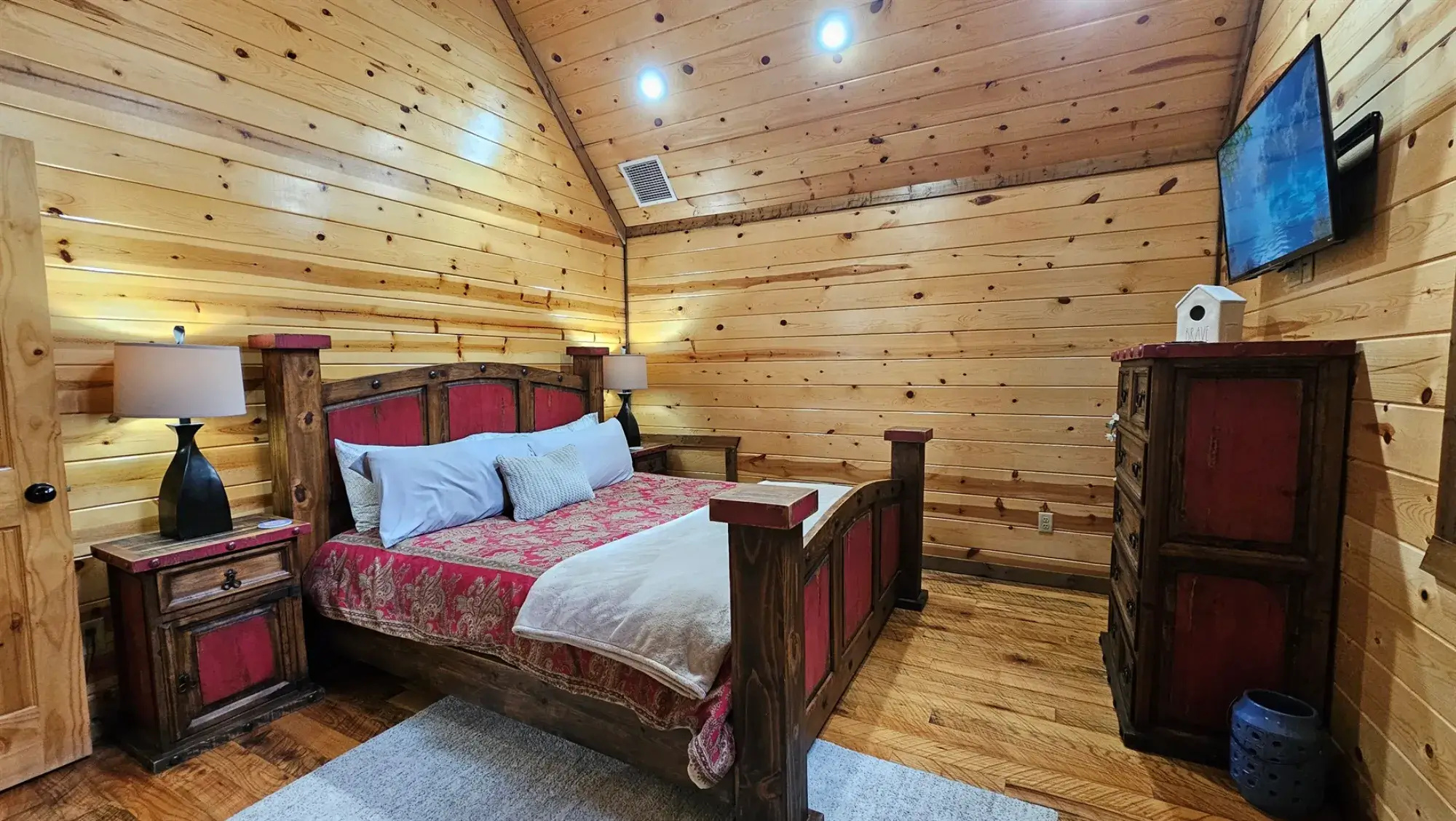 Bedroom 3: Rustic charm meets modern comfort with stunning wood accents and a serene view!