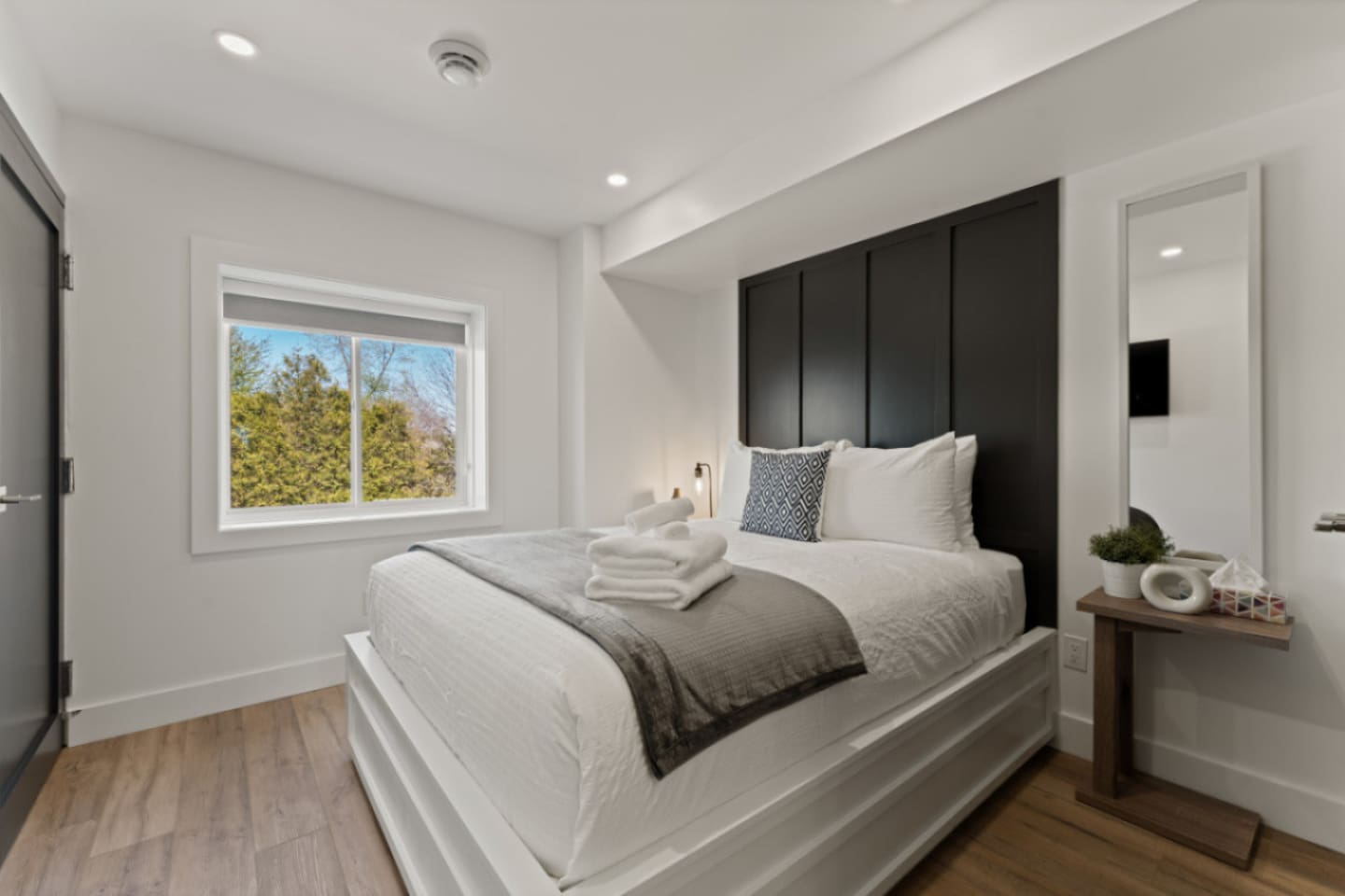 Queen Bedroom with Expansive windows framing urban views