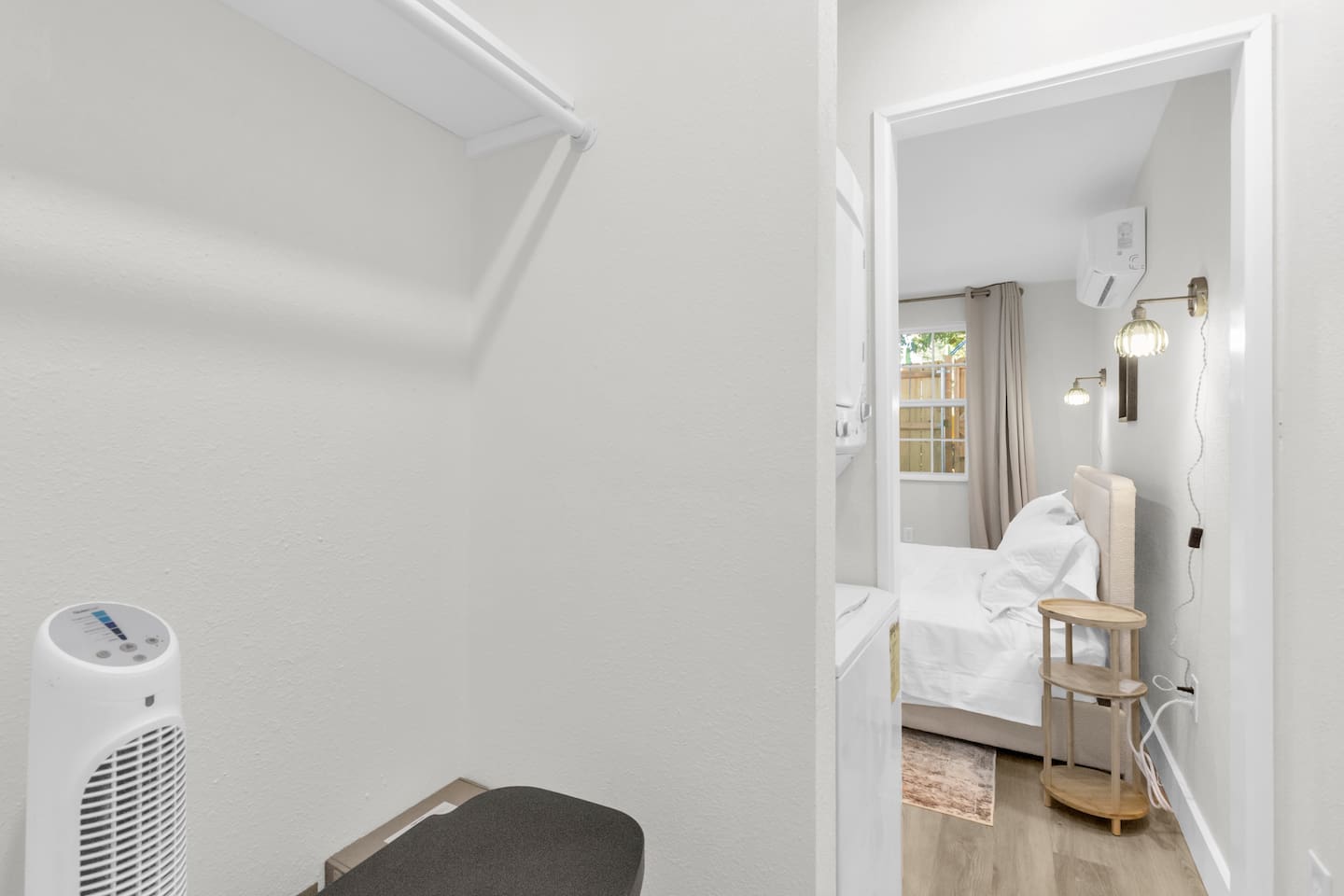 Washer and dryer in unit with extra clothing storage and a portable fan—perfect for long-term stays and added comfort.