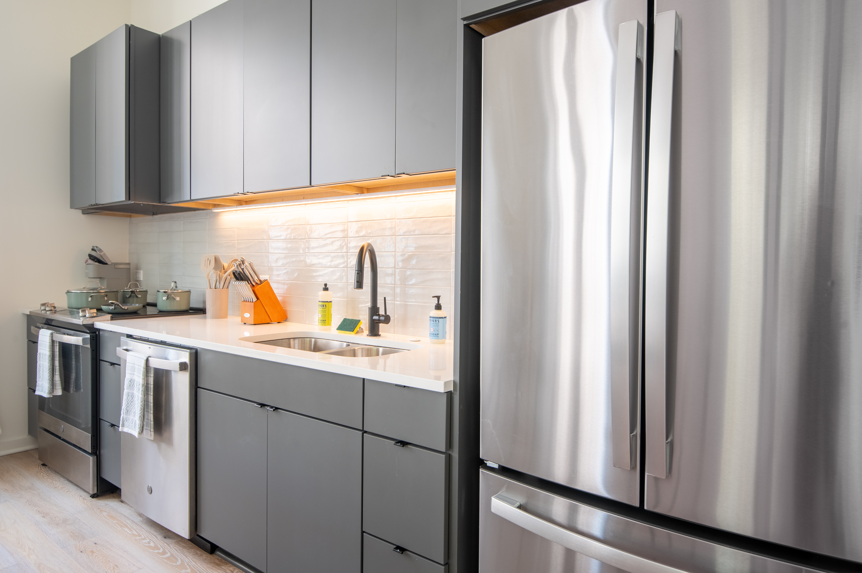Modern kitchen with stainless steel fridge and sleek cabinetry