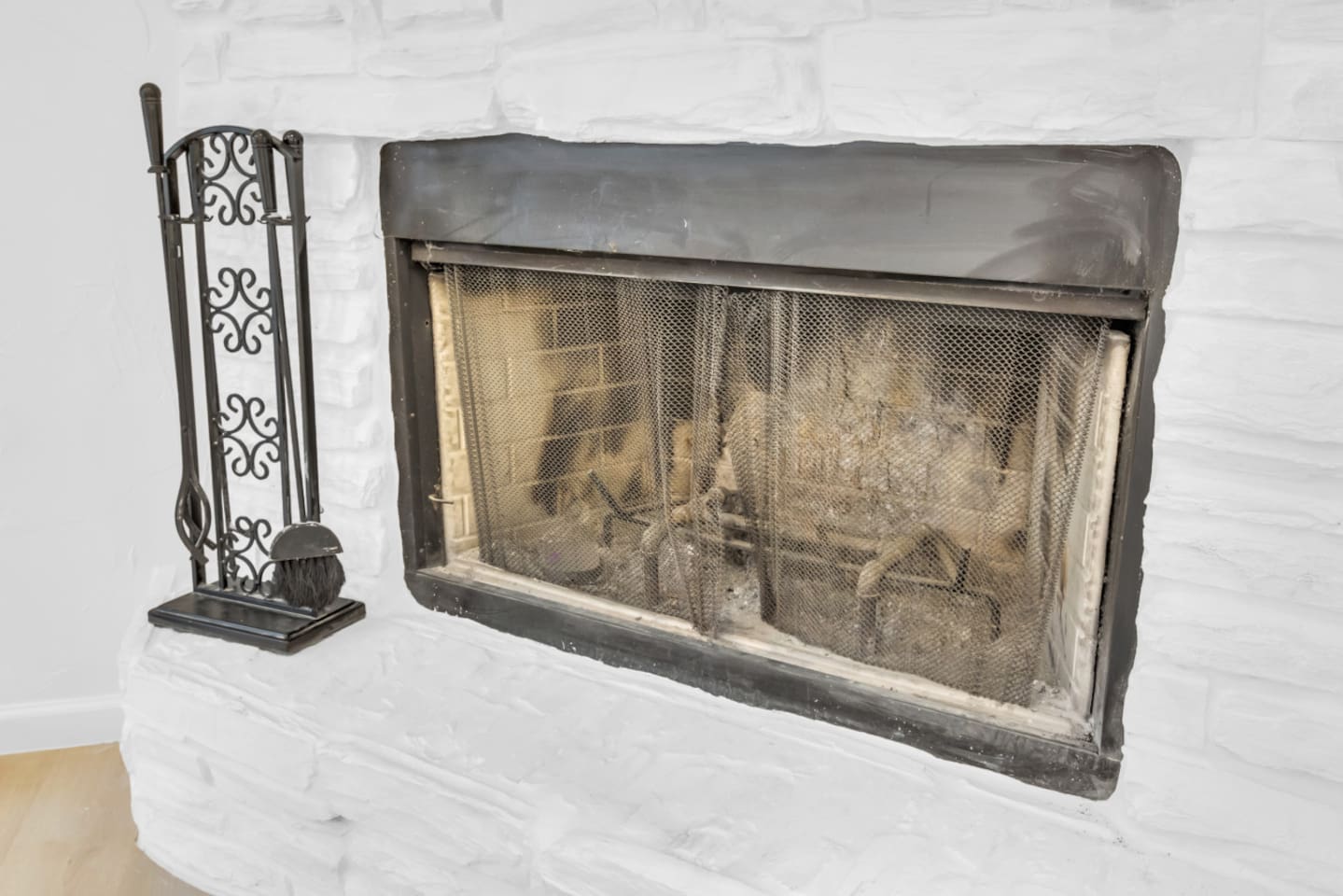 Charming indoor fireplace with fire tools, offering a warm and inviting centerpiece for family nights or seasonal stays. This indoor fireplace is available for guest use—please bring your own wood.