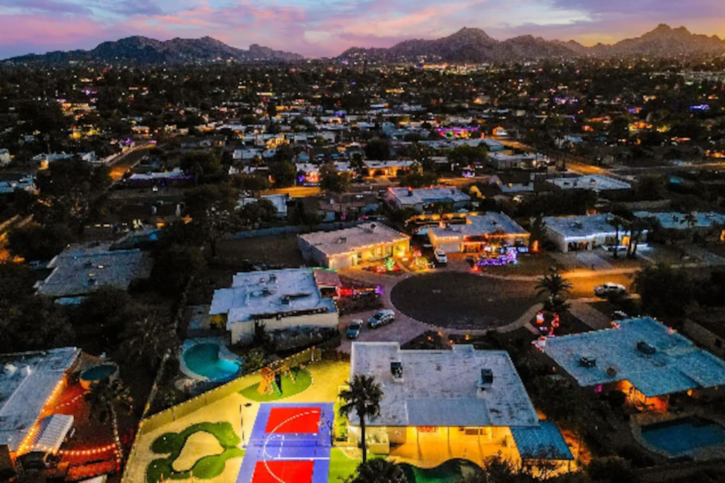 Camelback Mountain on the horizon, string lights below — Scottsdale views most guests only see from a rooftop bar.