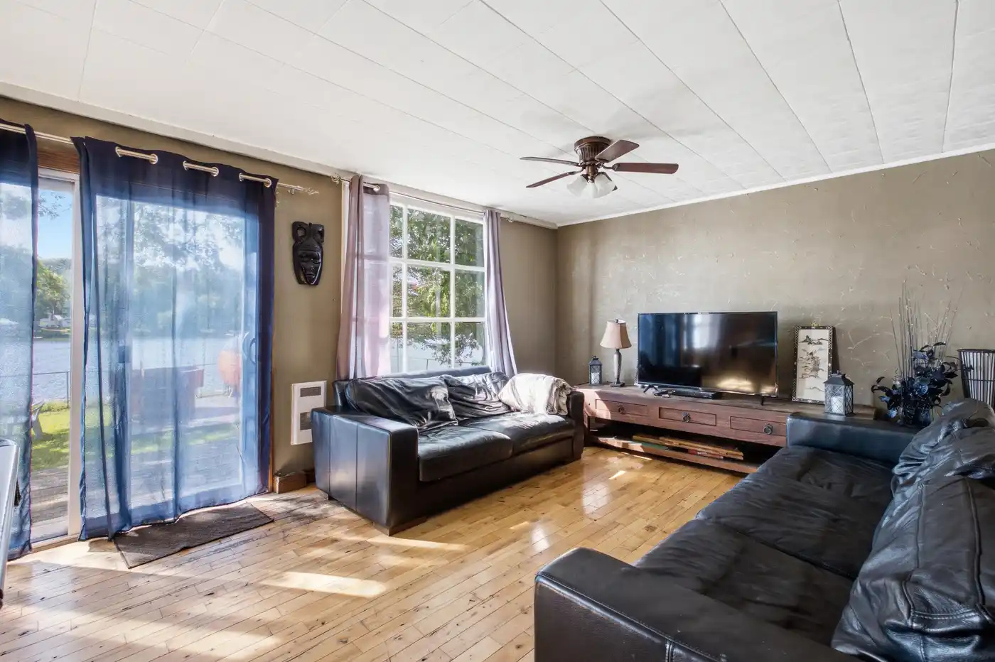 Bright living room with large windows and comfortable seating