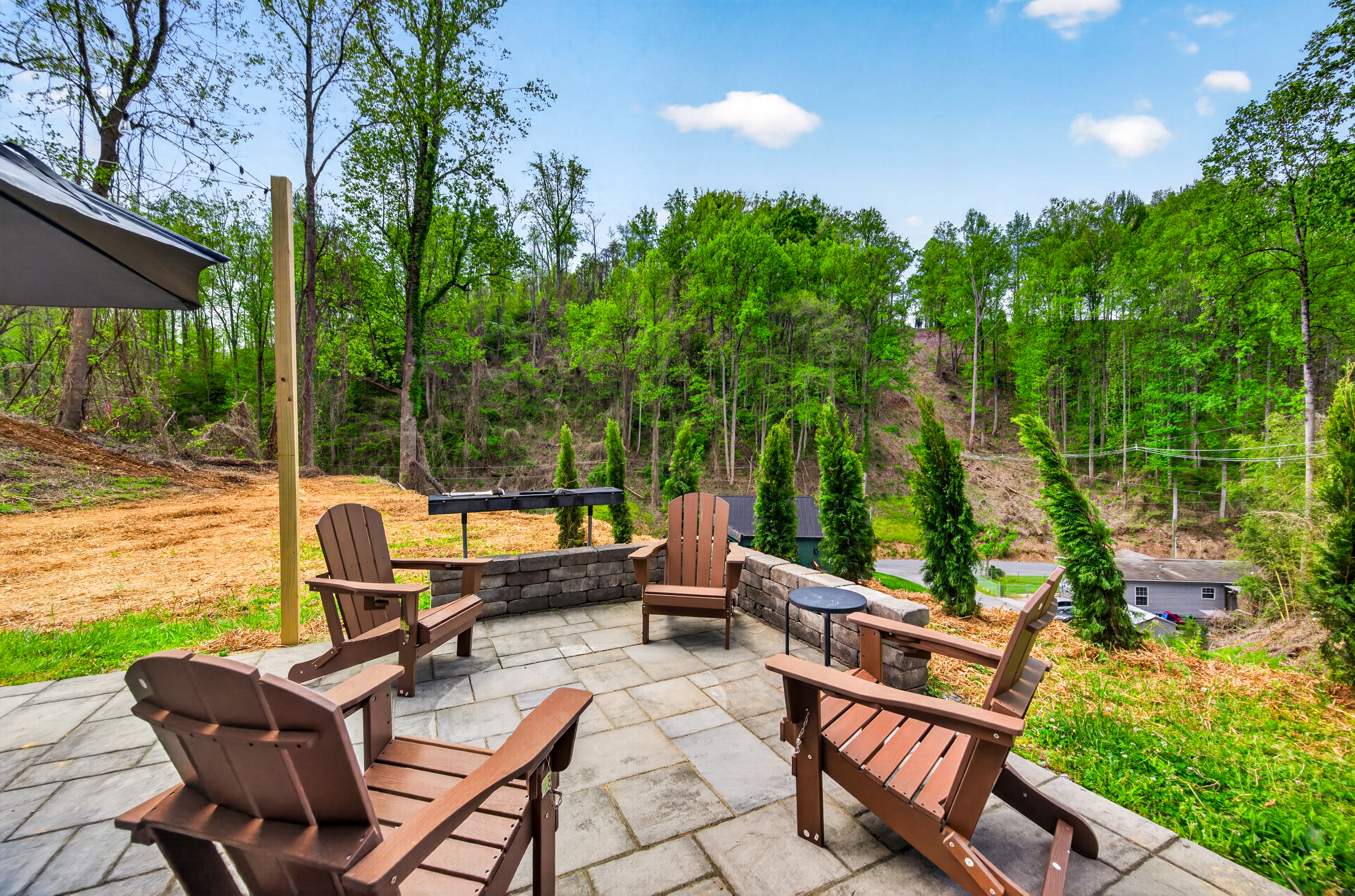Outdoor seating area with charcoal grill.