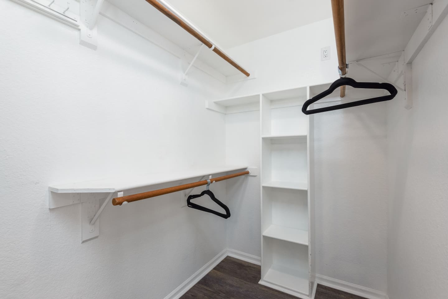 Practical closet setup with open shelving, hanging rods, and space to settle in.