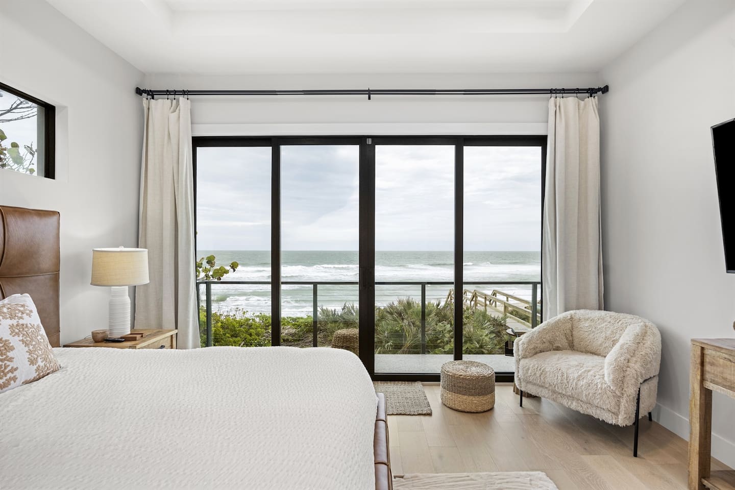 In the morning, you can open the patio doors of this upstairs master bedroom to watch the stunning sunrise over the ocean, creating the perfect start to your day.